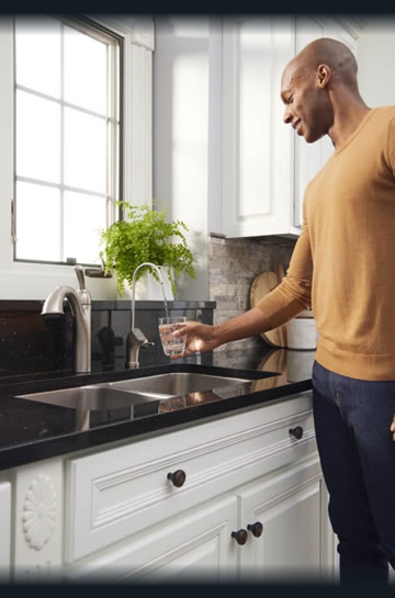 Man Getting Glass of Water